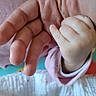 adult_hand, baby, blanket, bonding, close_up, cozy, cuddle, family, fingers, grip, hand, infant, nursery, palm, pink, skin, sleeve, soft, tiny, touch