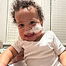 baby, child, curly_hair, medical_tape, white_onesie, smiling, indoor, window_blinds, happy, person, face, infant, cute, holding_hand, skin, young_child, portrait, bright, healthcare, toddler