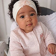 Maria a rejoint le concours — aidez-le/la à gagner de superbes lots ! baby, infant, toddler, headband, curly_hair, big_eyes, pink_outfit, onesie, highchair, portrait, indoor, adorable, sitting, closeup, face, eyelashes, nursery, hand, soft_texture, flower