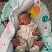 Scarlet joined the competition — help win amazing prizes! baby, sleeping, blanket, baby_seat, infant, clothing, sock, flower, comfort, peaceful, indoor, carpet, toy_pattern, face, person, child, cute, rest, relaxation, newborn