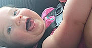 Scarlet joined the competition — help win amazing prizes! adult_arm, baby, car_interior, car_seat, child, close_up, eyes, face, hand, happy, indoor, infant, laughing, photography, pink_clothing, portrait, safety_harness, seated, smiling, vehicle