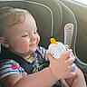 Scarlet is registered to the contest to win money with this photo: baby, car, car_seat, child, crumbs, family, feet, hands, indoor, infant, portrait, seatbelt, sitting, smiling, snack, striped_shirt, toy, travel, vehicle, white_toy
