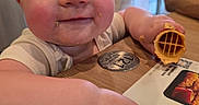 Scarlet joined the competition — help win amazing prizes! baby, casual, child, close_up, coin, crumbs, dining, face, family, food, hand, happy, indoor, infant, portrait, restaurant, smiling, table, waffle, wooden_table