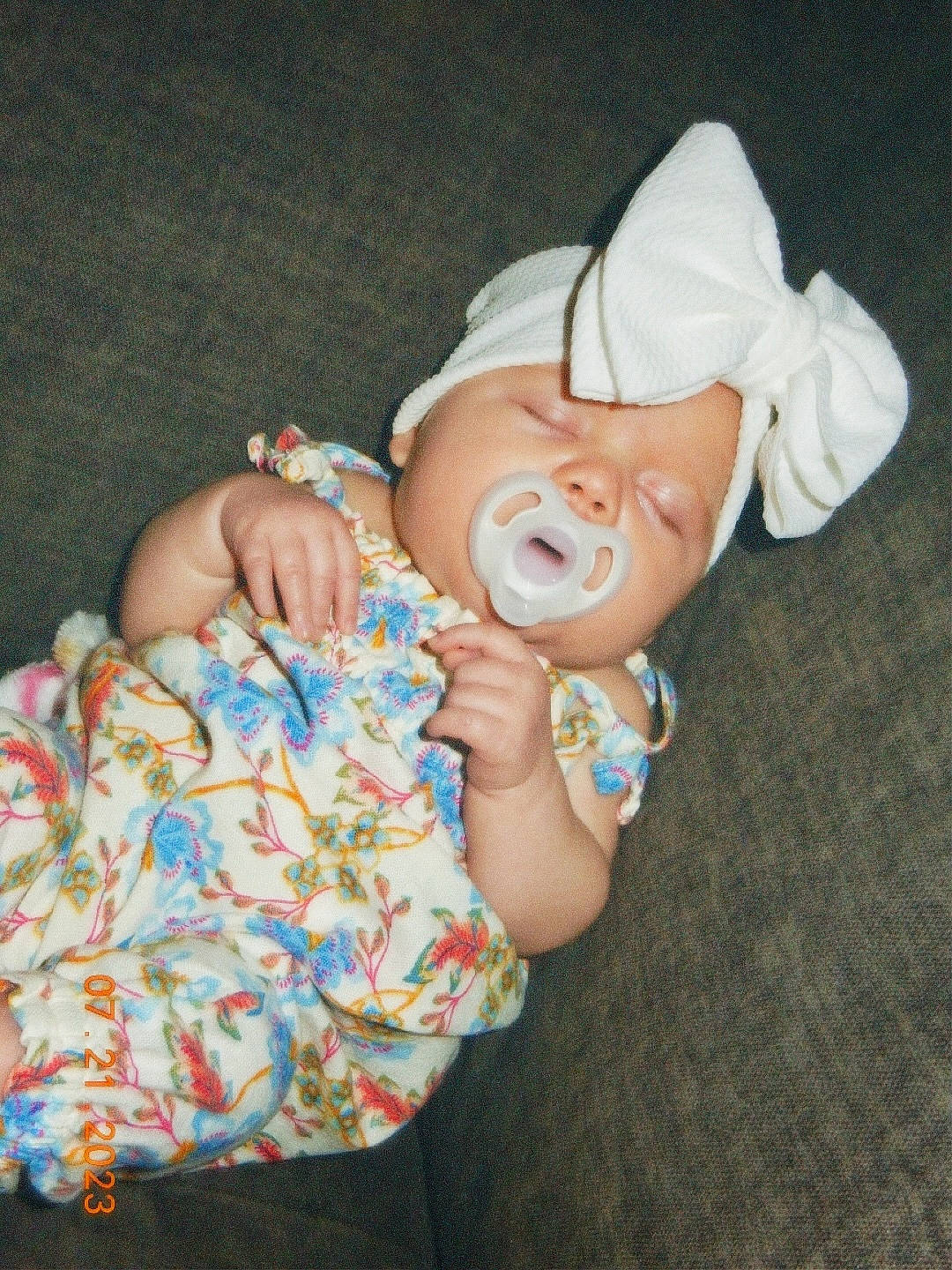 Miley is registered to the contest to win money with this photo: baby, baby_products, baby_toddler_clothing, child, comfort, fashion_accessory, finger, fun, gesture, hand, happy, hat, nail, pattern, person, sitting, skin, sleeve, sweetness, thumb