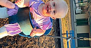 Ella Mae joined the competition — help win amazing prizes! baby, child, swing, playground, smiling, purple_clothing, outdoor, sunlight, happy, person, park, fun, play, seat, chain, hand, trees, daylight, ground, recreation