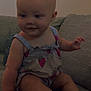Ella joined the competition — help win amazing prizes! baby, infant, child, couch, sofa, indoor, clothing, strawberry_pattern, smile, sitting, cute, cushion, furniture, person, skin, head, arm, leg, foot, happy