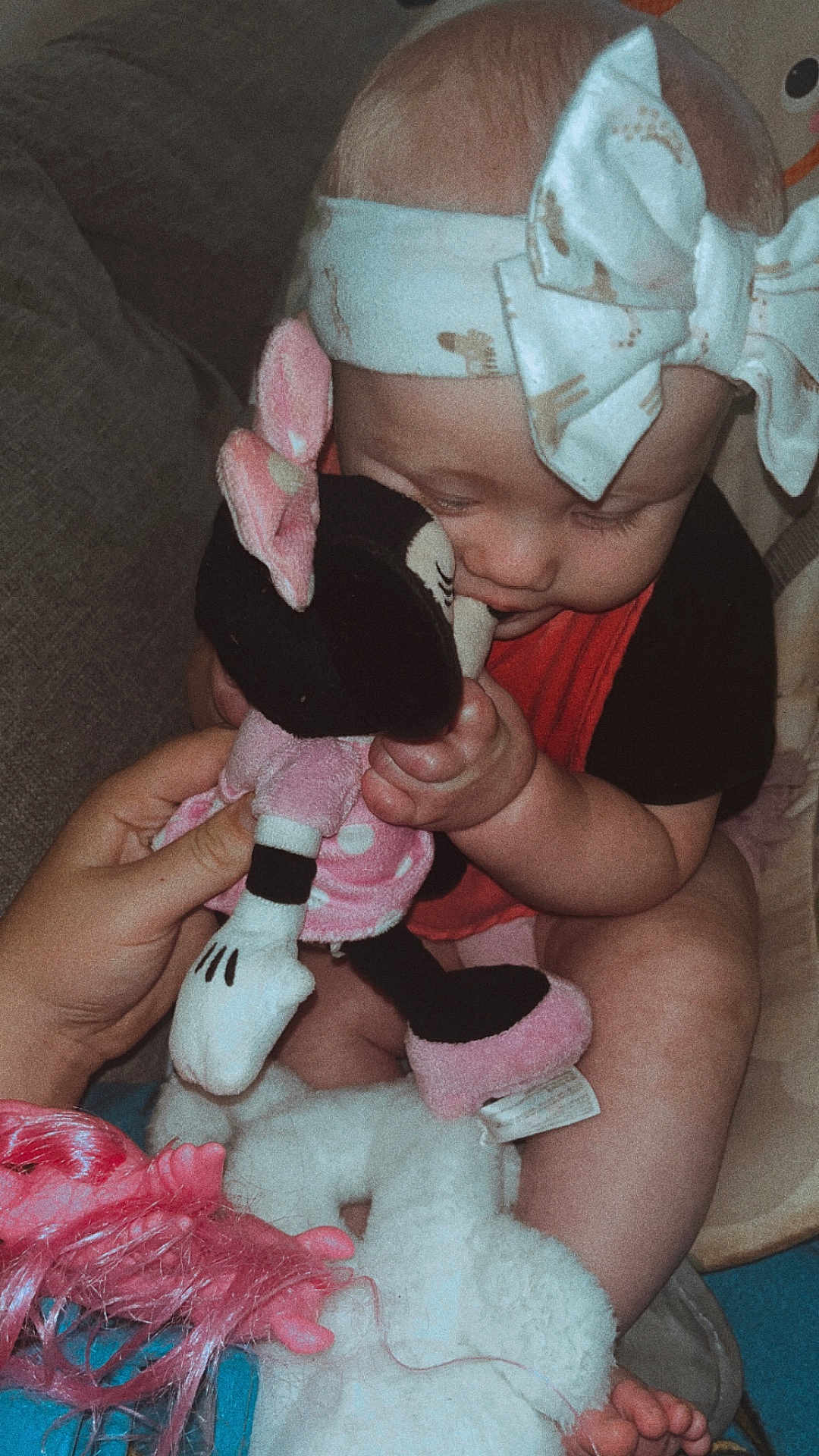 Ella joined the competition — help win amazing prizes! baby, child, headband, bow, plush_toy, minnie_mouse, hand, couch, soft_toy, cute, infant, seated, clothing, pink, black, white, legs, feet, indoor, cozy
