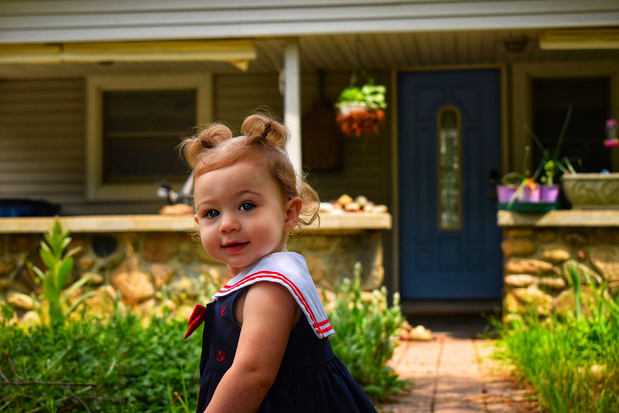 Alora is registered to the contest to win money with this photo: baby_toddler_clothing, child, door, event, flash_photography, flowerpot, fun, garden, grass, happy, house, leisure, people_in_nature, person, plant, sitting, smile, spring, toddler, window