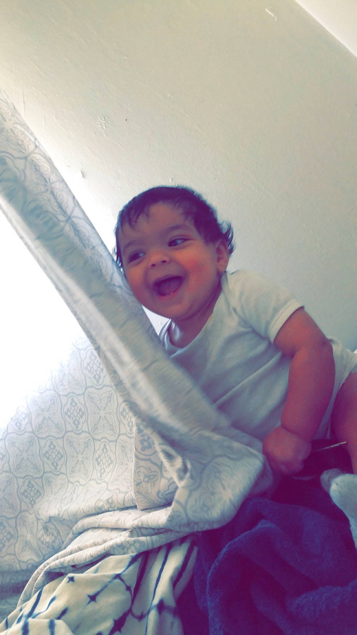 Jose Jr is registered to the contest to win money with this photo: automotive_exterior, child, comfort, elbow, eye, face, fun, happy, head, leisure, linens, mouth, person, shoulder, sitting, smile, tints_and_shades, toddler, vehicle_door, window