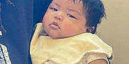 Miko joined the competition — help win amazing prizes! baby, infant, child, person, hands, clothing, bib, indoor, skin, face, arm, holding, cute, young, portrait, expression, resting, seated, comfort, people
