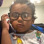 Kingston joined the competition — help win amazing prizes! child, glasses, curly_hair, indoor, shirt, cartoon, colorful, young, portrait, face, person, expression, hand, lighting, ceiling_light, home, casual, clothing, cute, toddler
