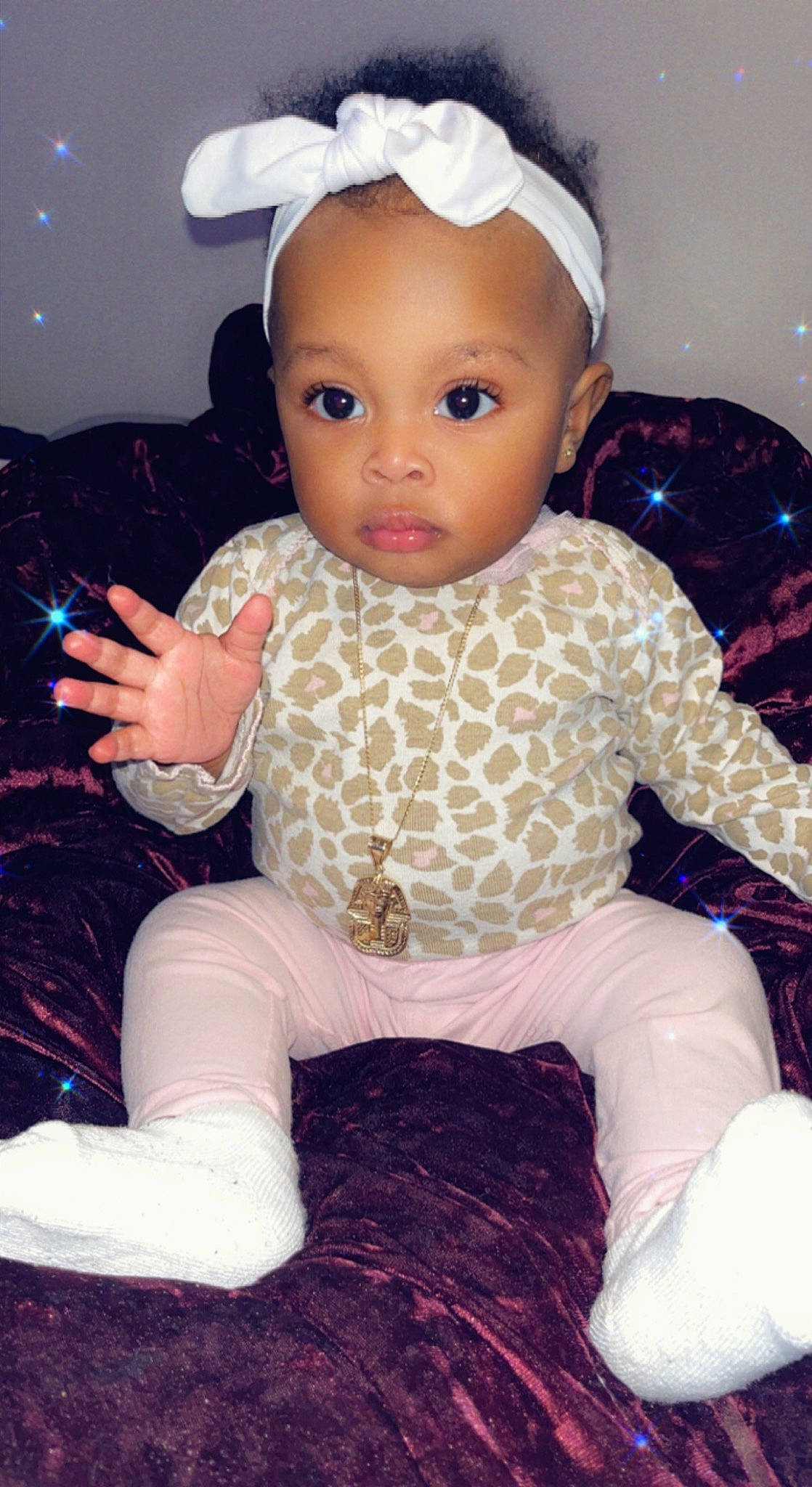 Shanel is registered to the contest to win money with this photo: baby, baby_toddler_clothing, cheek, child, costume_hat, fashion_accessory, finger, hairstyle, happy, head, pattern, people, person, pink, product, sitting, skin, sleeve, textile, toddler