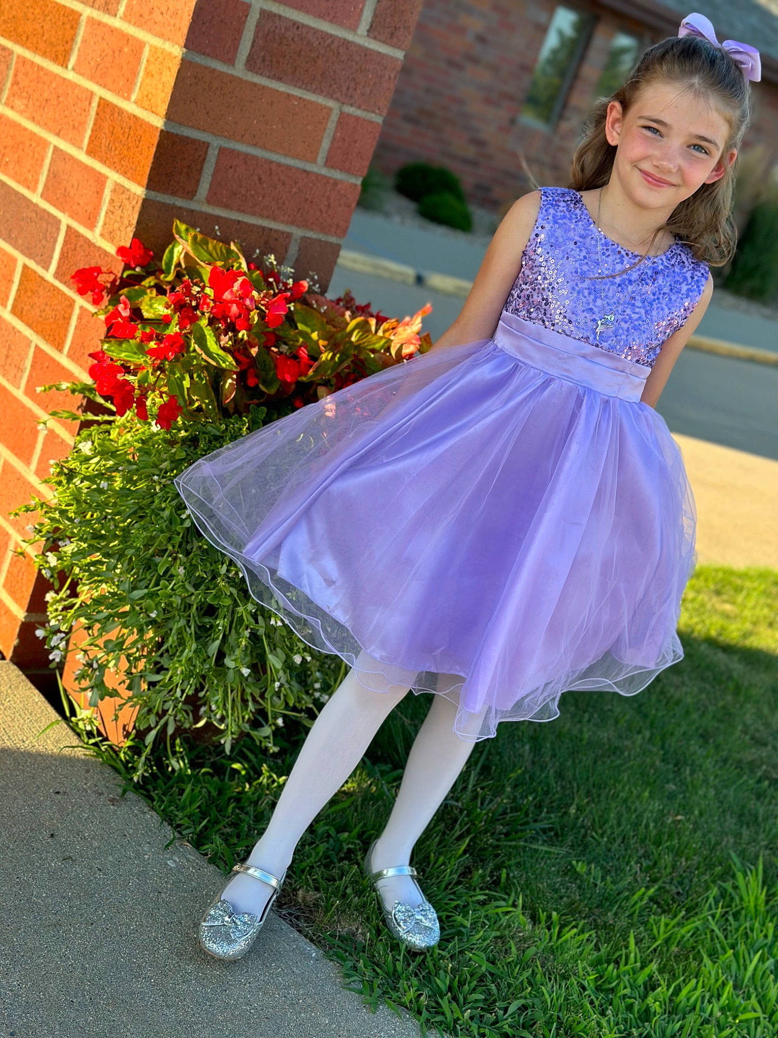 Evelynn is registered to the contest to win money with this photo: brick, day_dress, dress, electric_blue, face, fashion_design, formal_wear, grass, happy, high_heels, human_leg, joy, knee, one_piece_garment, person, petal, plant, smile, sportswear, thigh