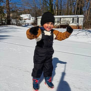 Iker joined the competition — help win amazing prizes! child, snow, winter, playful, gloves, boots, hat, outdoor, sunny, shadow, house, trees, cold, snowy_ground, smile, warm_clothing, young, person, fun, daytime