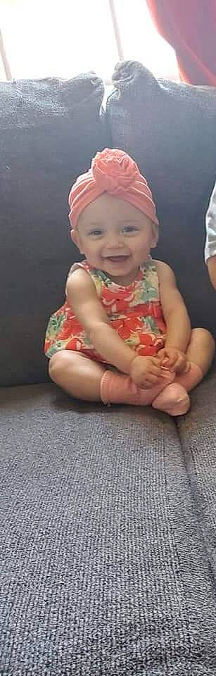 Anaya is registered to the contest to win money with this photo: arm, baby, baby_toddler_clothing, cap, cheek, eye, face, finger, gesture, hairstyle, happy, head, headwear, joy, lip, mouth, nose, person, photograph, pink