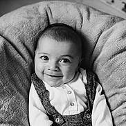 Gabriel participe au concours pour gagner de l'argent avec cette photo : baby, infant, smile, face, eyes, clothing, buttoned_shirt, overalls, cushion, plush, texture, portrait, black_and_white, cozy, happy, child, cute, indoor, young, person
