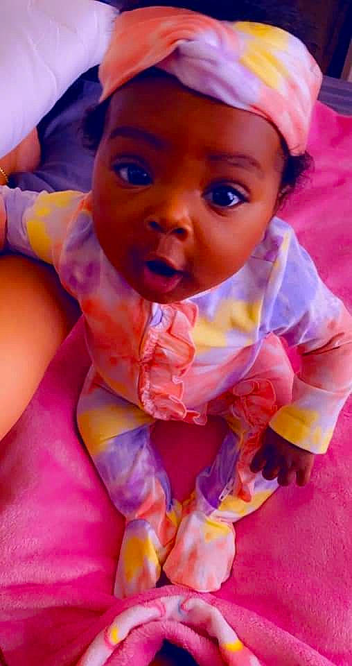 Taraji is registered to the contest to win money with this photo: baby, baby_toddler_clothing, cap, cheek, child, event, fashion_accessory, finger, fun, hand, happy, headgear, headwear, lip, magenta, nose, orange, person, pink, purple