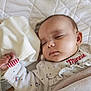 Inaya participe au concours pour gagner de l'argent avec cette photo : baby, sleeping, infant, blanket, quilt, clothing, cute, face, hand, cozy, soft, indoor, child, peaceful, resting, bed, cute_outfit, minnie, polka_dots, warm