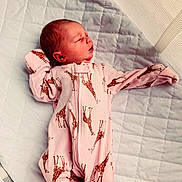 Oaklynn joined the competition — help win amazing prizes! baby, newborn, sleeping, infant, pink, onesie, giraffe_pattern, quilt, blanket, bed, child, peaceful, cute, soft, clothing, portrait, rest, young, indoors, person
