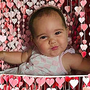 Sky joined the competition — help win amazing prizes! accessories, baby, clothing, crib, dress, face, furniture, happy, head, heart, infantbed, jewelry, necklace, newborn, person, photography, portrait, sitting, smile, symbol