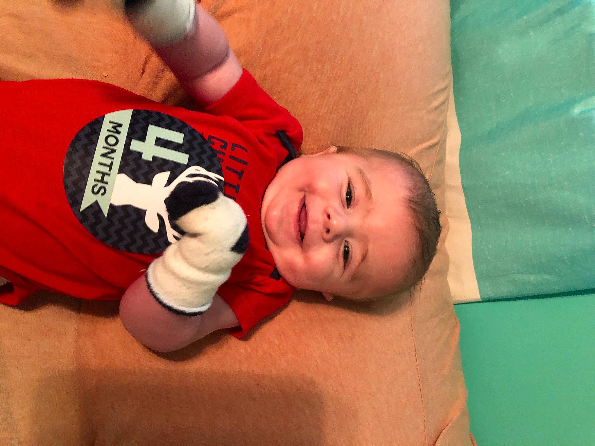 Caiden is registered to the contest to win money with this photo: arm, baby, child, finger, joy, mouth, muscle, person, thumb