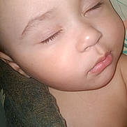 Blake is registered to the contest to win money with this photo: baby, sleeping, close_up, face, skin, eyelashes, blanket, peaceful, child, portrait, infant, rest, cute, young, soft, calm, indoors, head, nose, lips