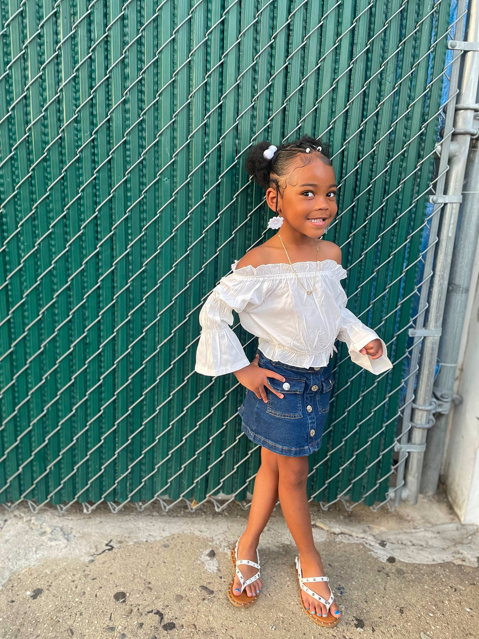 Paige is registered to the contest to win money with this photo: chain_link_fencing, child, denim, electric_blue, fashion_design, fun, happy, human_leg, joy, knee, leg, leisure, mesh, net, pattern, person, sandal, shoe, thigh, trunk