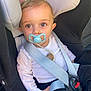 baby, pacifier, car_seat, child, infant, seat_belt, safety, clothing, white_shirt, black_pants, close_up, cute, human, young_child, portrait, indoor, seat_harness, child_safety, person, baby_face