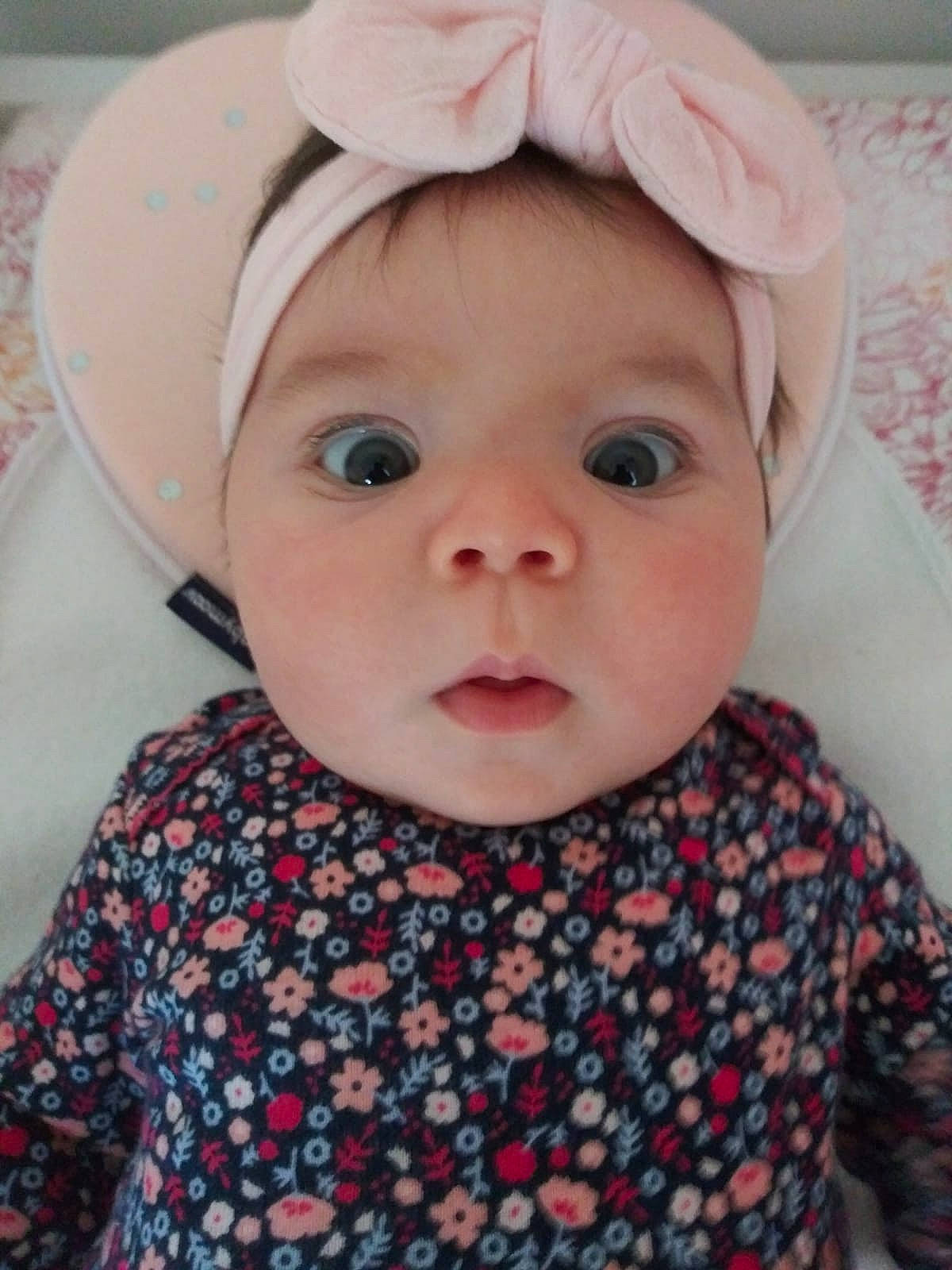 Jaylene is registered to the contest to win money with this photo: baby, cheek, child, ear, eye, face, hair_accessory, hat, head, headgear, lip, outerwear, person, pink, skin, smile, toddler