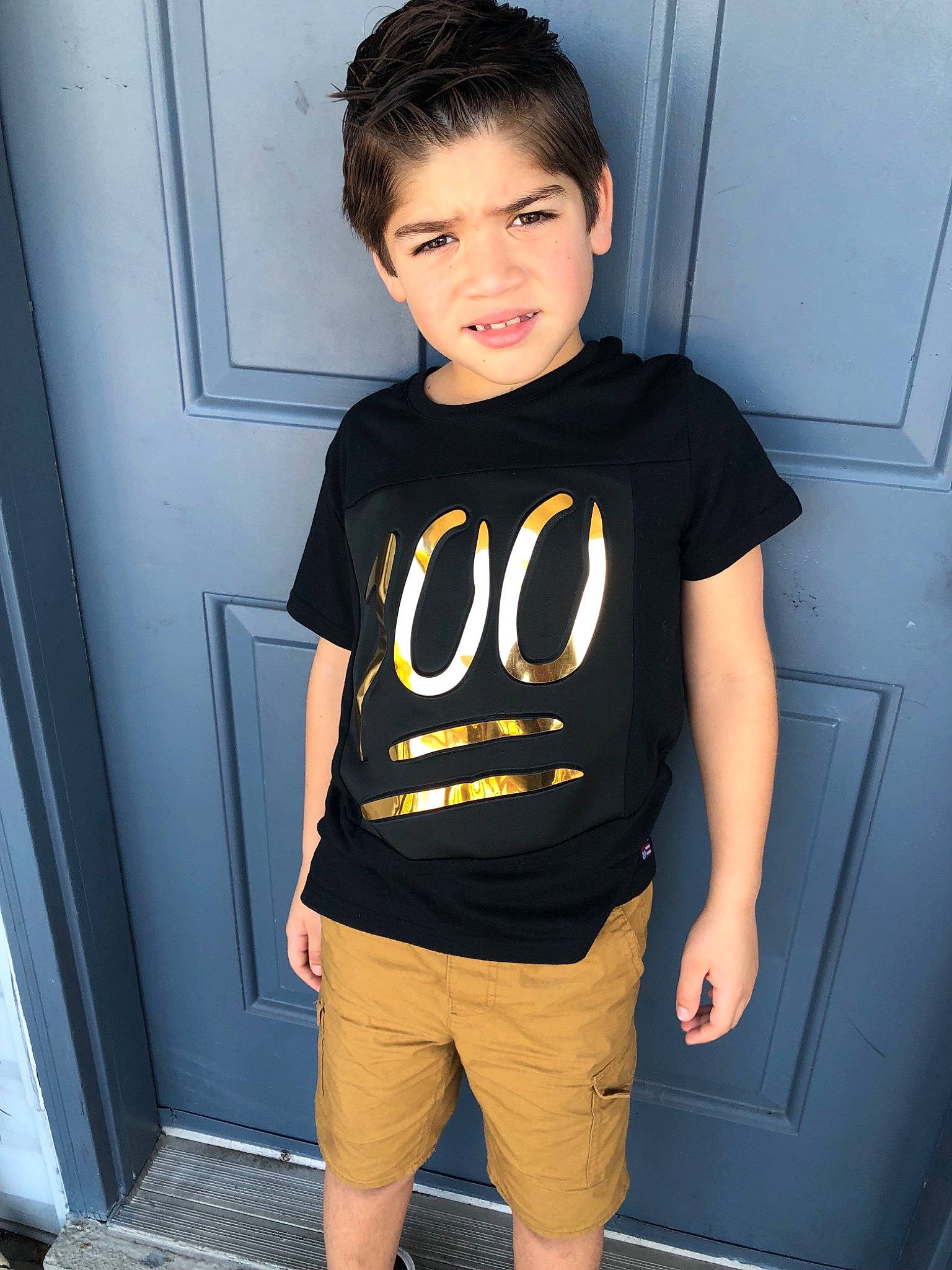 Nathanael joined the competition — help win amazing prizes! black_hair, child, child_model, clothing, cool, male, neck, outerwear, person, shorts, shoulder, sleeve, smile, sorrow, standing, t_shirt, top, yellow