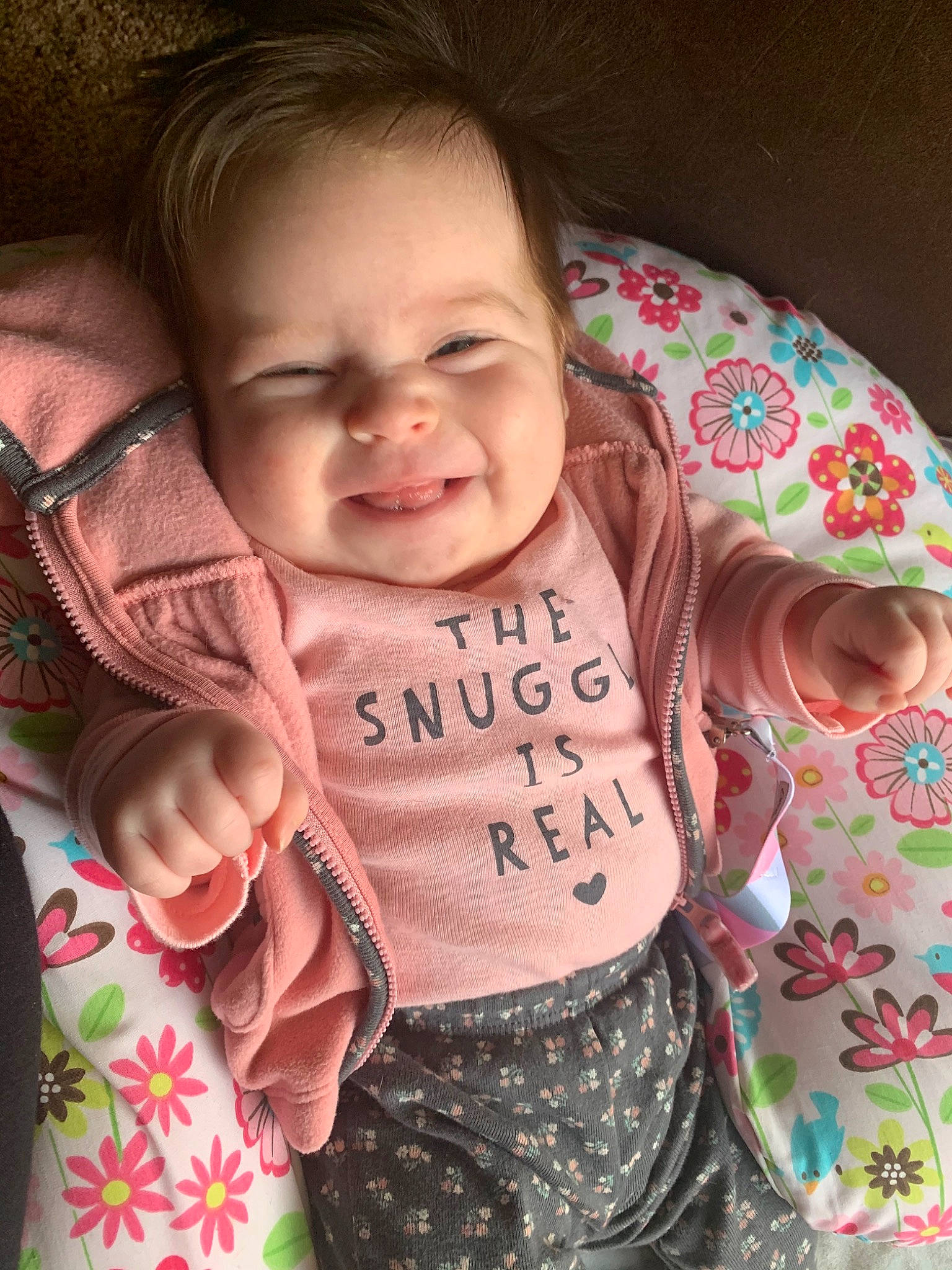 Journee is registered to the contest to win money with this photo: baby, baby_toddler_clothing, cheek, child, cool, face, facial_expression, fun, hand, happy, head, joy, nose, pattern, person, pink, product, skin, sleeve, smile