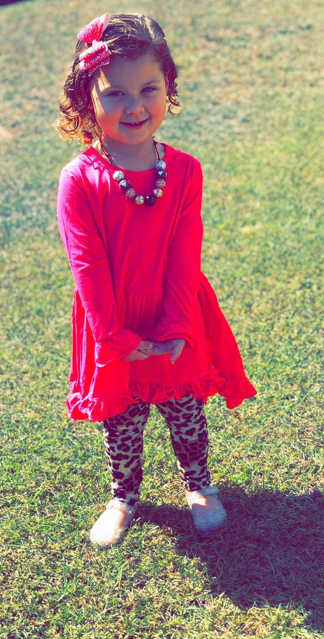 Amelia is registered to the contest to win money with this photo: child, child_model, clothing, dress, footwear, grass, joy, leggings, magenta, outerwear, pattern, person, pink, red, shoe, sleeve, style, tights, toddler