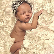 Kenzlie is registered to the contest to win money with this photo: adorable, baby, blanket, child, closeup, cozy, cute, diaper, flower_pattern, headwear, infant, lying_down, newborn, peaceful, portrait, resting, skin, sleeping, soft_texture, tiara