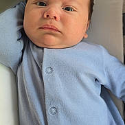 Maximiliano joined the competition — help win amazing prizes! baby, infant, face, blue_clothing, onesie, blanket, cushion, resting, indoors, child, young, portrait, skin, expression, serious, head, hair, sleepwear, closeup, newborn