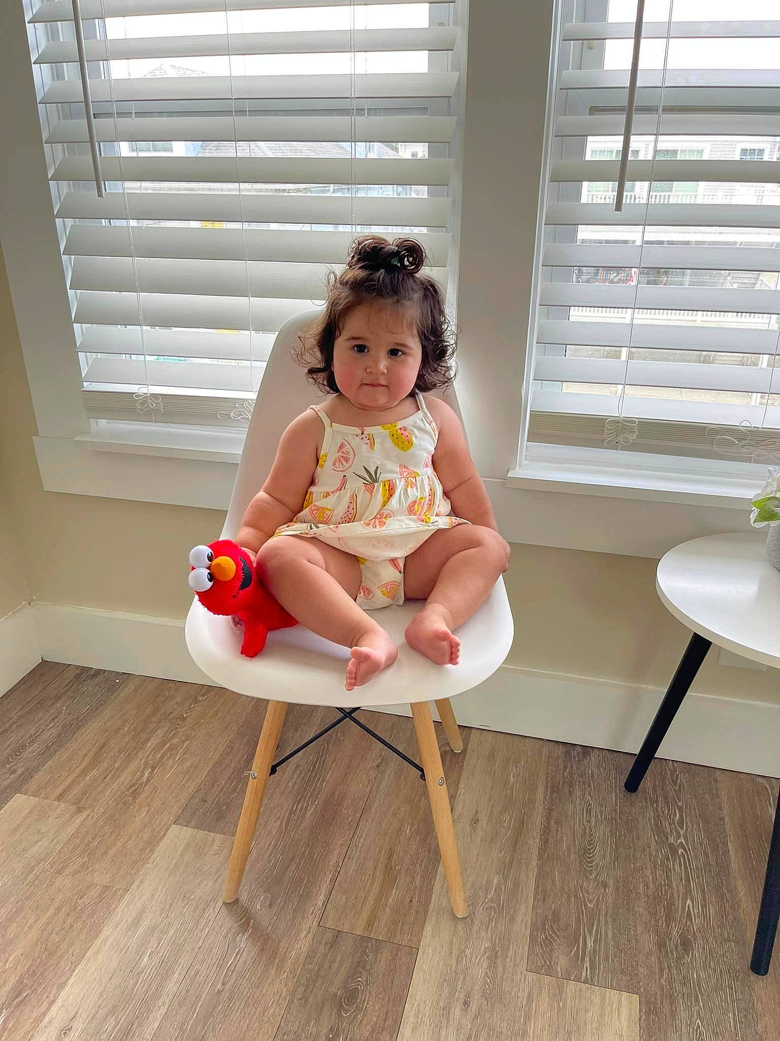 Xena is registered to the contest to win money with this photo: baby, baby_toddler_clothing, chair, child, comfort, floor, flooring, foot, hardwood, human_leg, knee, laminate_flooring, leisure, peach, person, sitting, thigh, toddler, window_blind, wood