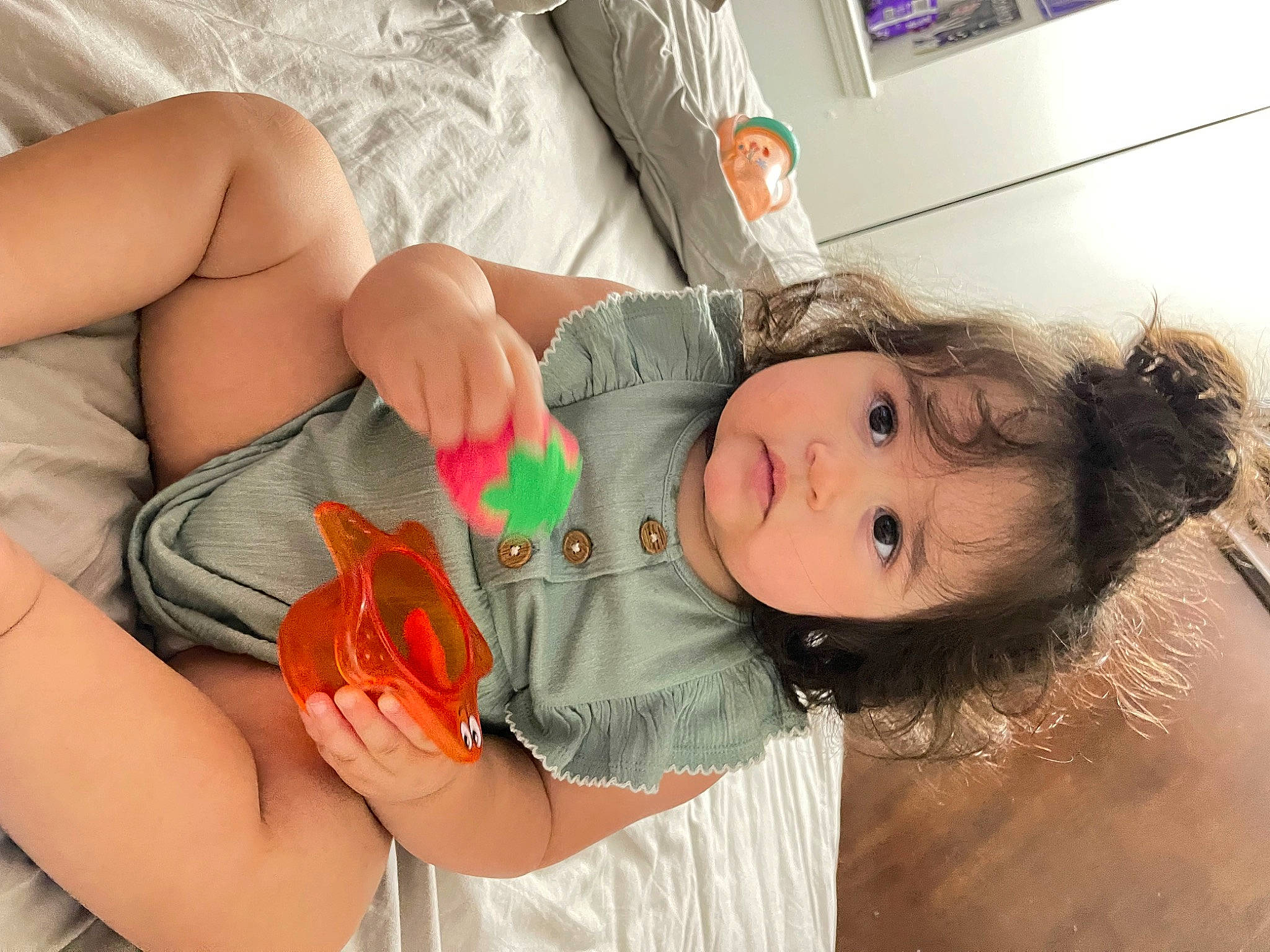 Xena is registered to the contest to win money with this photo: chest, child, dress, eye, eyelash, finger, fun, hand, happy, head, human_body, joint, mouth, nail, nose, orange, person, skin, thumb, toddler