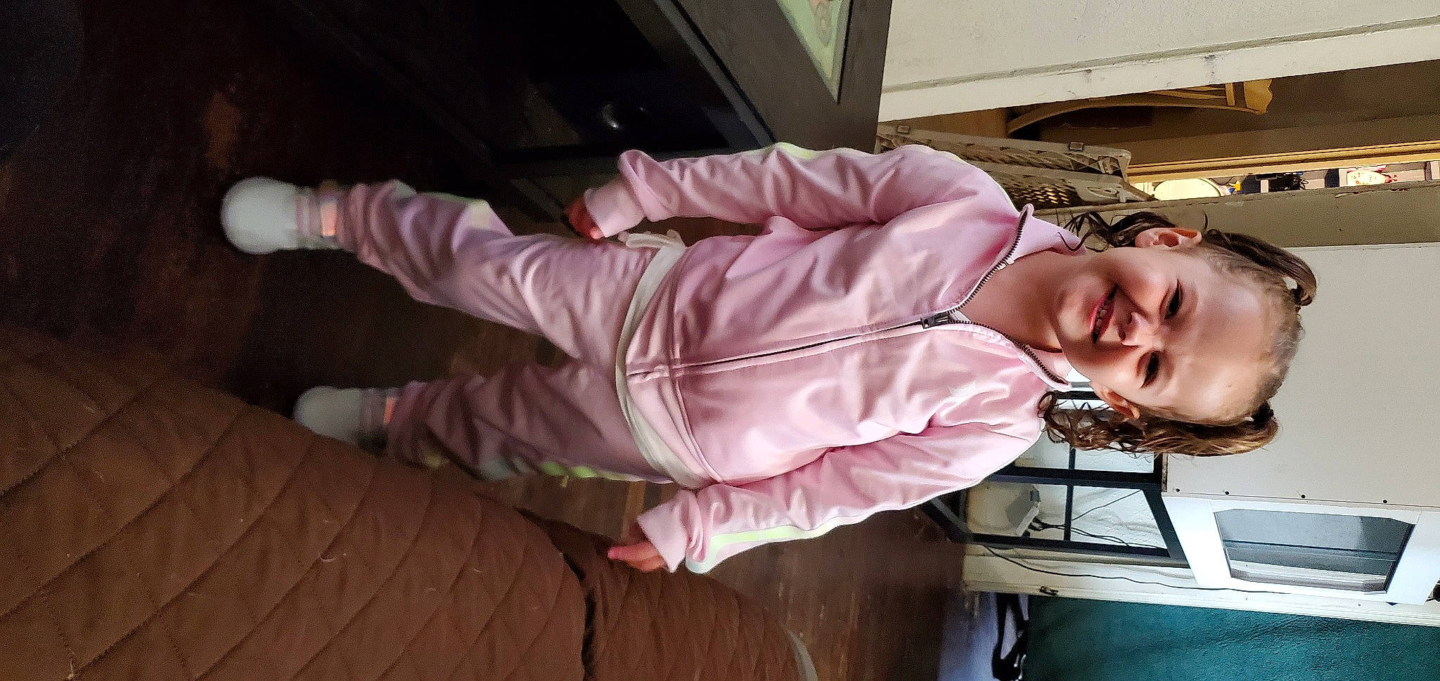 Catherine is registered to the contest to win money with this photo: child, comfort, flooring, foot, fun, hardwood, human_leg, joy, knee, person, pink, room, sitting, smile, sock, textile, wood