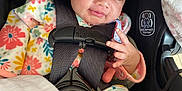 Analaxia is registered to the contest to win money with this photo: baby, infant, car_seat, child, smile, pacifier, blanket, headwrap, floral_pattern, onesie, safety_harness, pink, black, seatbelt, clothing, cute, indoors, portrait, person, baby_girl