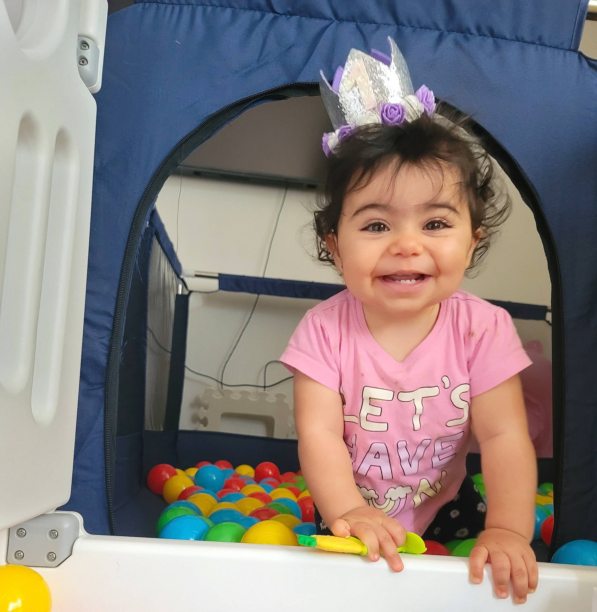 Joy is registered to the contest to win money with this photo: baby, baby_playing_with_toys, baby_toddler_clothing, ball, ball_pit, child, fashion_accessory, fun, happy, joy, magenta, person, photograph, pink, play, product, purple, smile, snapshot, toddler