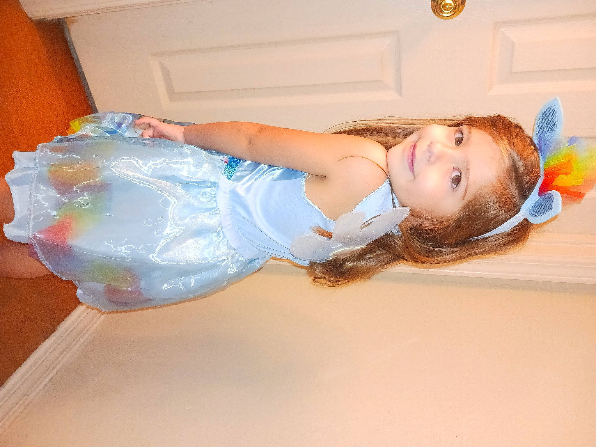 Nova is registered to the contest to win money with this photo: abdomen, baby_toddler_clothing, brown_hair, child, dress, elbow, electric_blue, fun, happy, headband, human_leg, joy, knee, long_hair, person, shoulder, sitting, smile, thigh, toddler