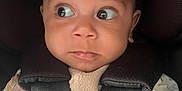 Romeo is registered to the contest to win money with this photo: baby, child, car_seat, sensor_safe, hands, wide_eyes, curious, infant, clothing, straps, buckle, seat, closeup, portrait, young_child, sitting, cute, indoors, safety, expression