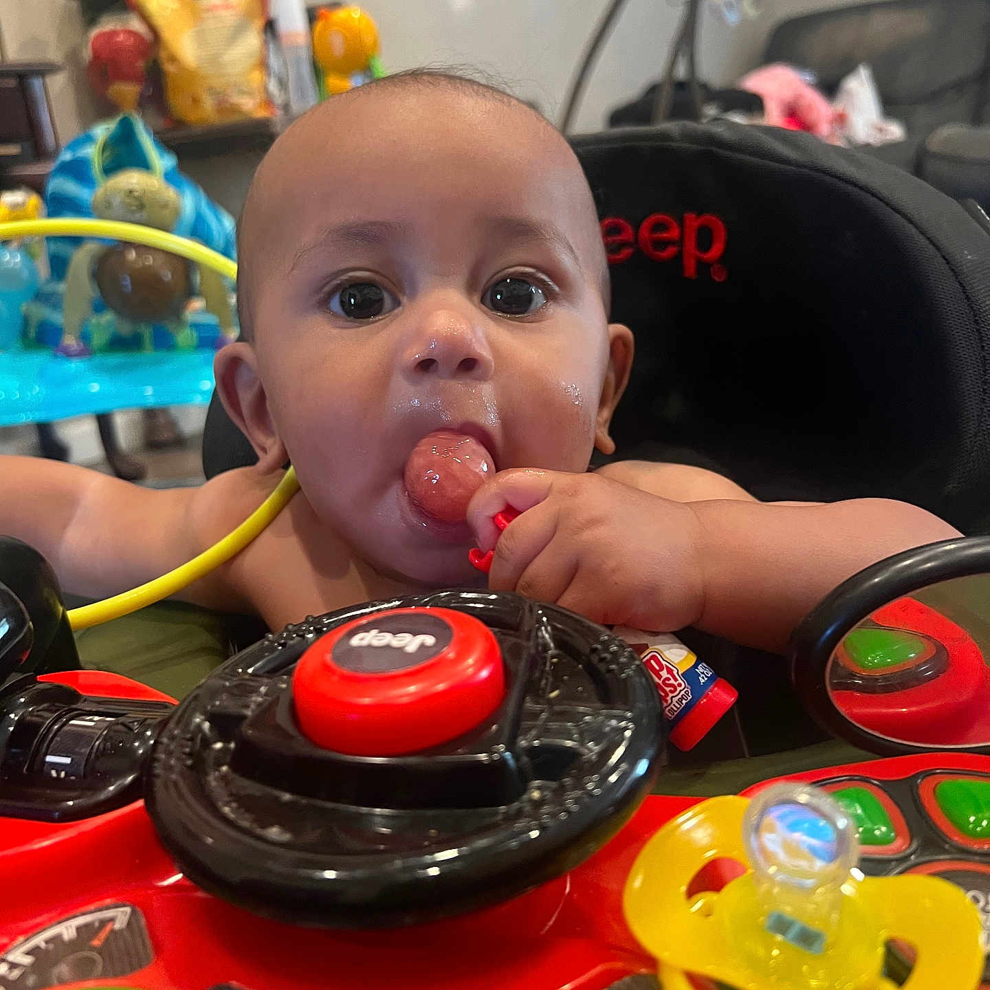Romeo joined the competition — help win amazing prizes! baby, chewing, child, closeup, colorful, curious, face, hand, home, indoor, infant, jeep, lollipop, mirror, pacifier, playful, seat, steering_wheel, toy, toy_car