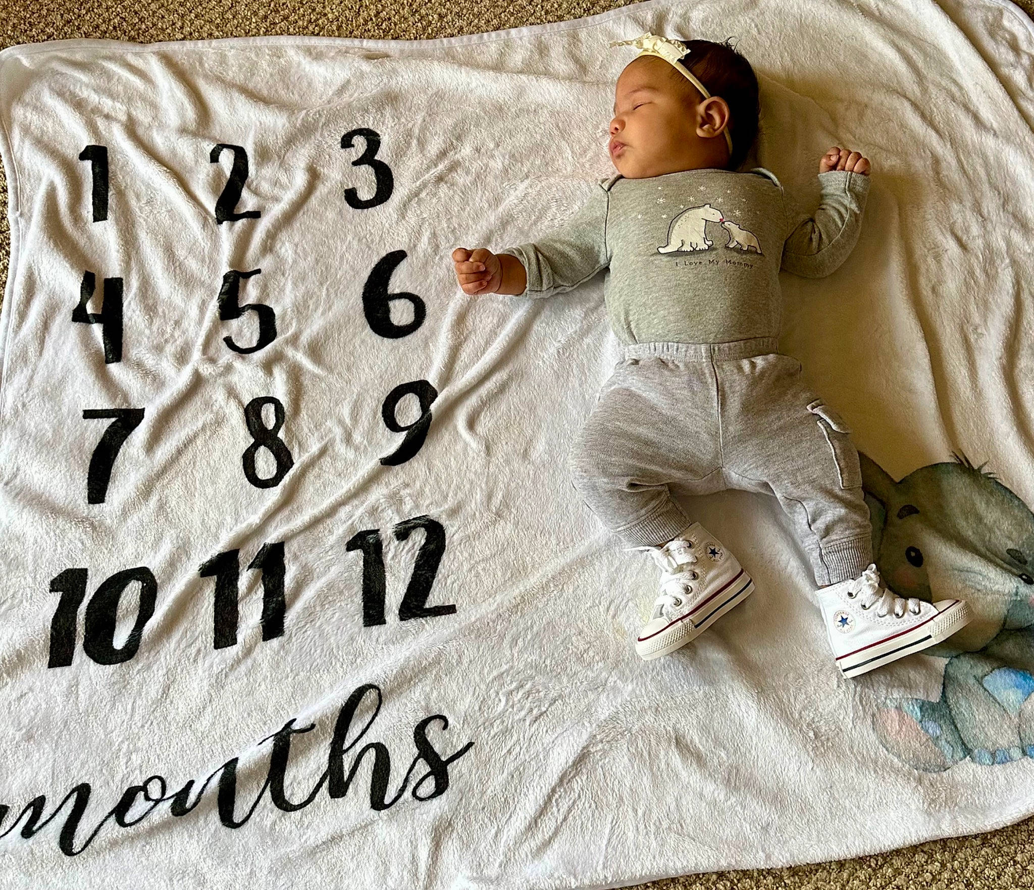 Zaneya is registered to the contest to win money with this photo: baby, baby_sleeping, baby_toddler_clothing, bedding, brand, child, comfort, font, gesture, happy, linens, pattern, person, rectangle, sleeve, t_shirt, throw_pillow, toddler, wood