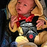 Lincoln is registered to the contest to win money with this photo: baby, infant, car_seat, yellow_onesie, hood, harness, pacifier, child, cute, seated, patterned_fabric, clothing, newborn, indoor, soft_texture, safety, baby_care, portrait, small_hands, curious
