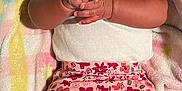 Deja is registered to the contest to win money with this photo: baby, infant, child, blanket, headband, flower, white_top, floral_pants, pink, pastel_colors, hands, face, eyes, lying_down, cute, soft_texture, patterned_clothing, socks, indoors, portrait