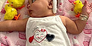 Amariah joined the competition — help win amazing prizes! baby, bunny_ears, blanket, yellow_chick, toy, onesie, bracelet, pink, cute, infant, lying_down, face, earrings, pattern, soft_toy, child, smiling_heart, decor, playful, cozy