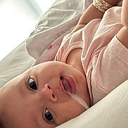 Amariah joined the competition — help win amazing prizes! baby, infant, close_up, face, eyes, pink_clothing, soft_toys, lying_down, curious, expression, skin, mouth, head, child, indoors, blanket, cozy, resting, newborn, portrait