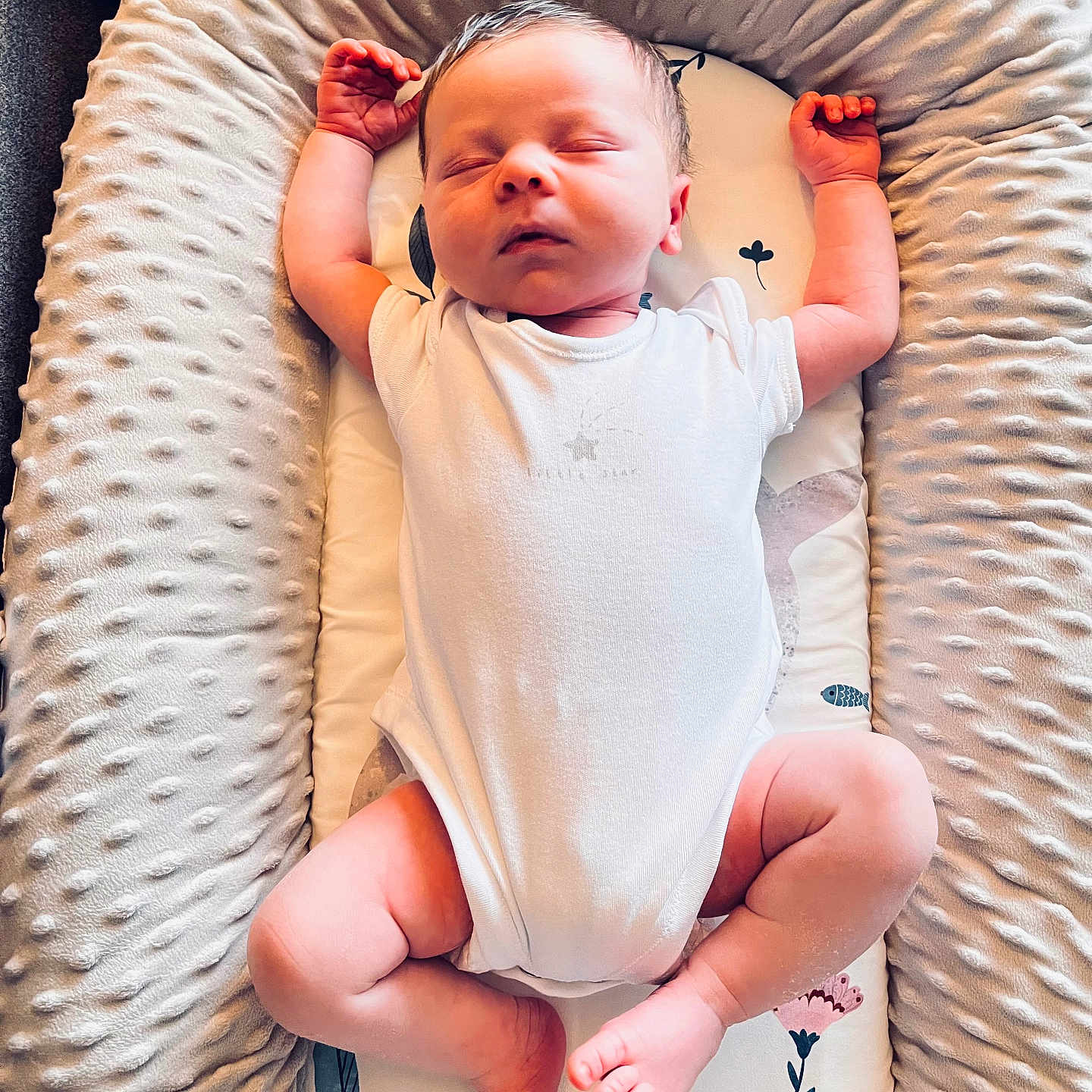 Perrin is registered to the contest to win money with this photo: arms_up, baby, blanket, comfort, cushion, face, feet, floral_pattern, head, indoors, infant, legs, newborn, peace, peaceful, rest, skin, sleeping, soft_texture, white_clothing