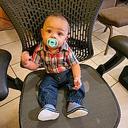 Charles Smith joined the competition — help win amazing prizes! baby, child, pacifier, plaid_shirt, denim_pants, shoes, office_chair, tile_floor, indoor, curious, seated, young_child, infant, cute, casual_clothing, modern_furniture, baby_boy, portrait, home_environment, floor_tiles