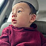 Noah is registered to the contest to win money with this photo: baby, child, face, profile, sweater, maroon, clothing, car, seat, window, looking, curious, portrait, skin, hair, head, indoors, seatbelt, soft_light, expression